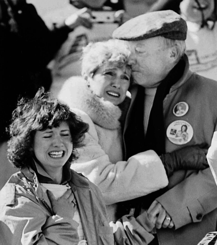 A irmã de Christa McAuliffe, Betsy, e os pais Ed e Grace Corrigan reagem angustiados à explosão do ônibus espacial. (Imagem: Jim Cole / AP).